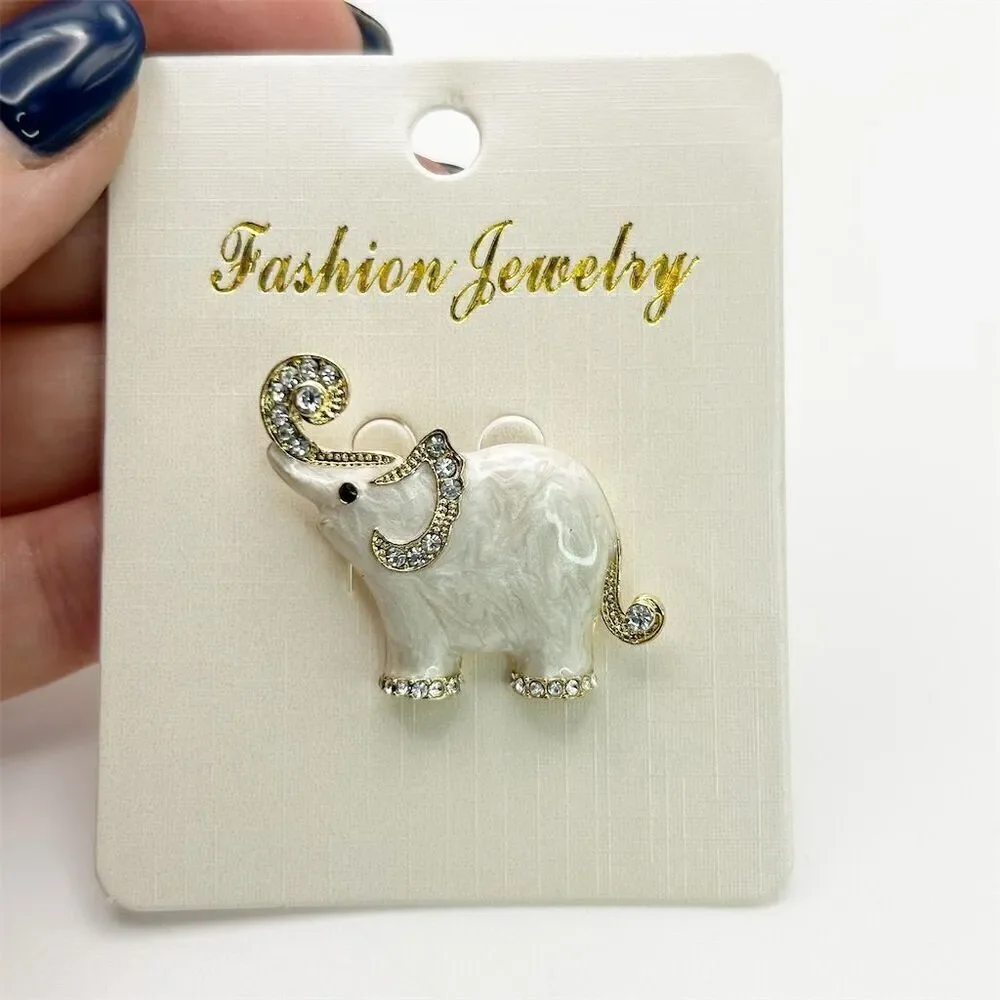 Small Dainty White Elephant Brooch Pin Rhinestone Accents Gold Tone Trunk Up